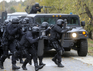 swat team breaking down door